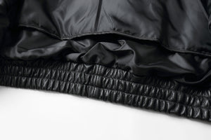 Close-up of REED Bomber Jacket's black genuine leather and inner lining detail