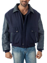 Charger l&#39;image dans la galerie, Man wearing REED leather varsity bomber jacket with wool body and leather sleeves, made in USA, classic and stylish design.

