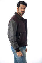 Charger l&#39;image dans la galerie, Model wearing REED men&#39;s leather varsity bomber jacket with wool body and leather sleeves, crafted in USA, stylish mid-weight design.
