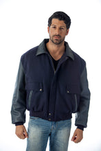 Charger l&#39;image dans la galerie, Men&#39;s leather varsity bomber jacket with wool body and leather sleeves, made in USA, worn by model with blue jeans.
