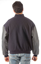 Charger l&#39;image dans la galerie, Model wearing REED Men&#39;s Premium Varsity Leather/Wool Jacket, USA-made, back view showcasing leather sleeves and classic design.
