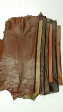 Load image into Gallery viewer, Various shades of REED leather hides in sheepskin, 7 to 10 SF whole skins, featuring soft and durable textures, perfect for crafting.
