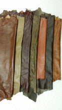 Load image into Gallery viewer, Various shades of REED leather hides arranged on a surface, showcasing soft and durable sheepskin leather in 7 to 10 SF sizes.
