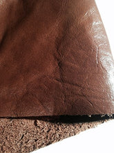 Load image into Gallery viewer, Close-up of REED leather hide, whole skin in rich brown color, showcasing soft, durable texture with antique finish, ideal for crafts.
