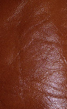 Load image into Gallery viewer, Close-up of luxurious REED sheepskin leather hide, soft and durable, showcasing a rich brown color and textured antique finish.
