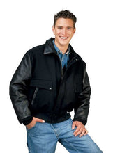Charger l&#39;image dans la galerie, Man wearing black leather varsity bomber jacket with denim jeans, showcasing classic REED design, made in USA.
